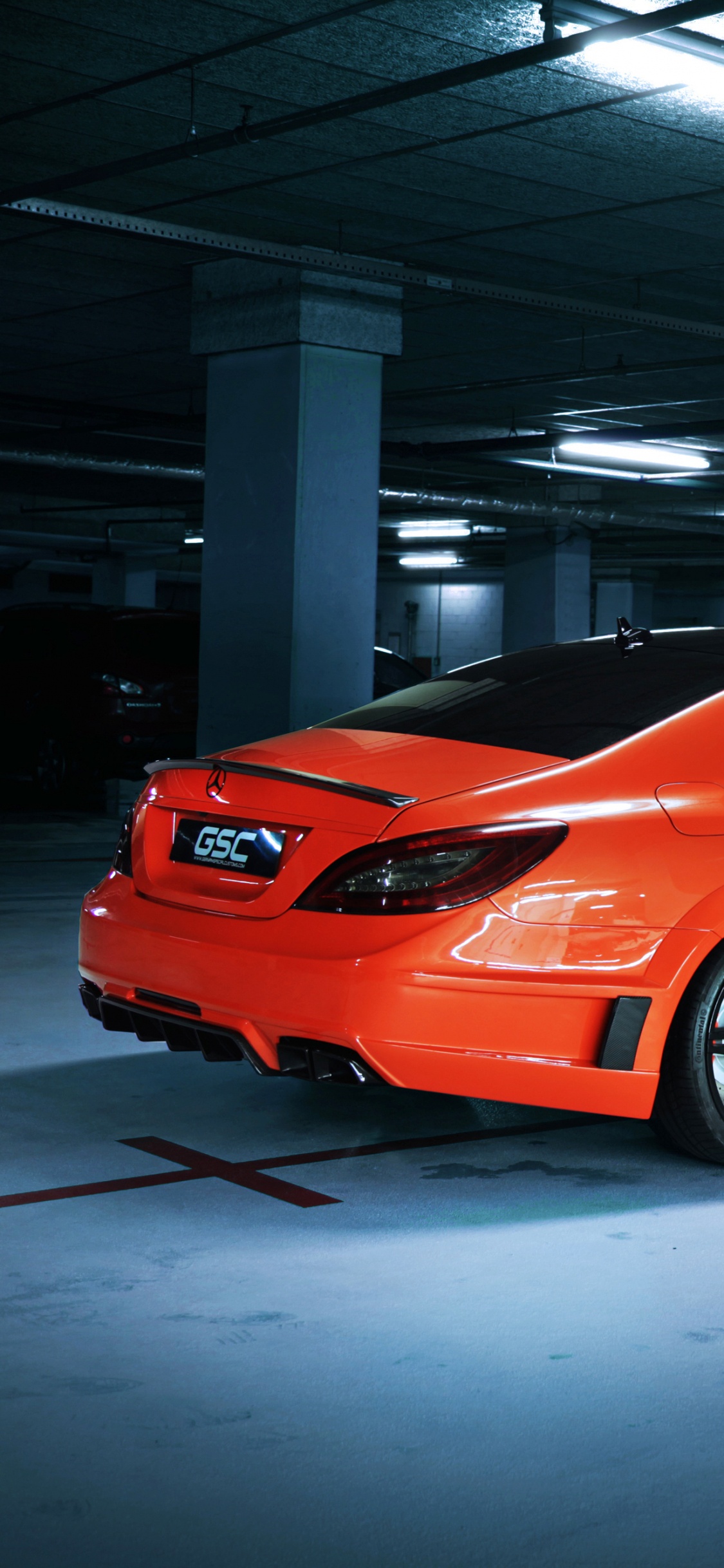 Orange Ferrari 458 Italia Parked in Building. Wallpaper in 1125x2436 Resolution