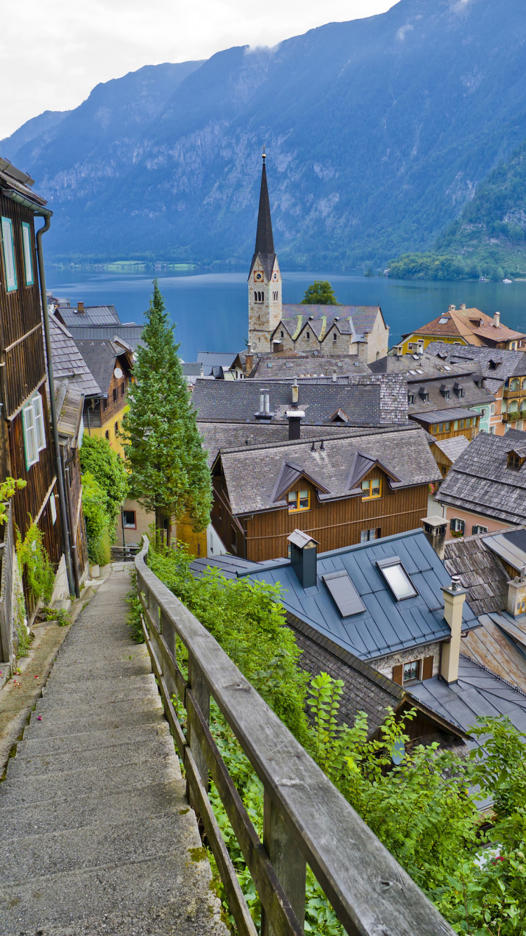 Brown and White Concrete House Near Body of Water During Daytime. Wallpaper in 750x1334 Resolution
