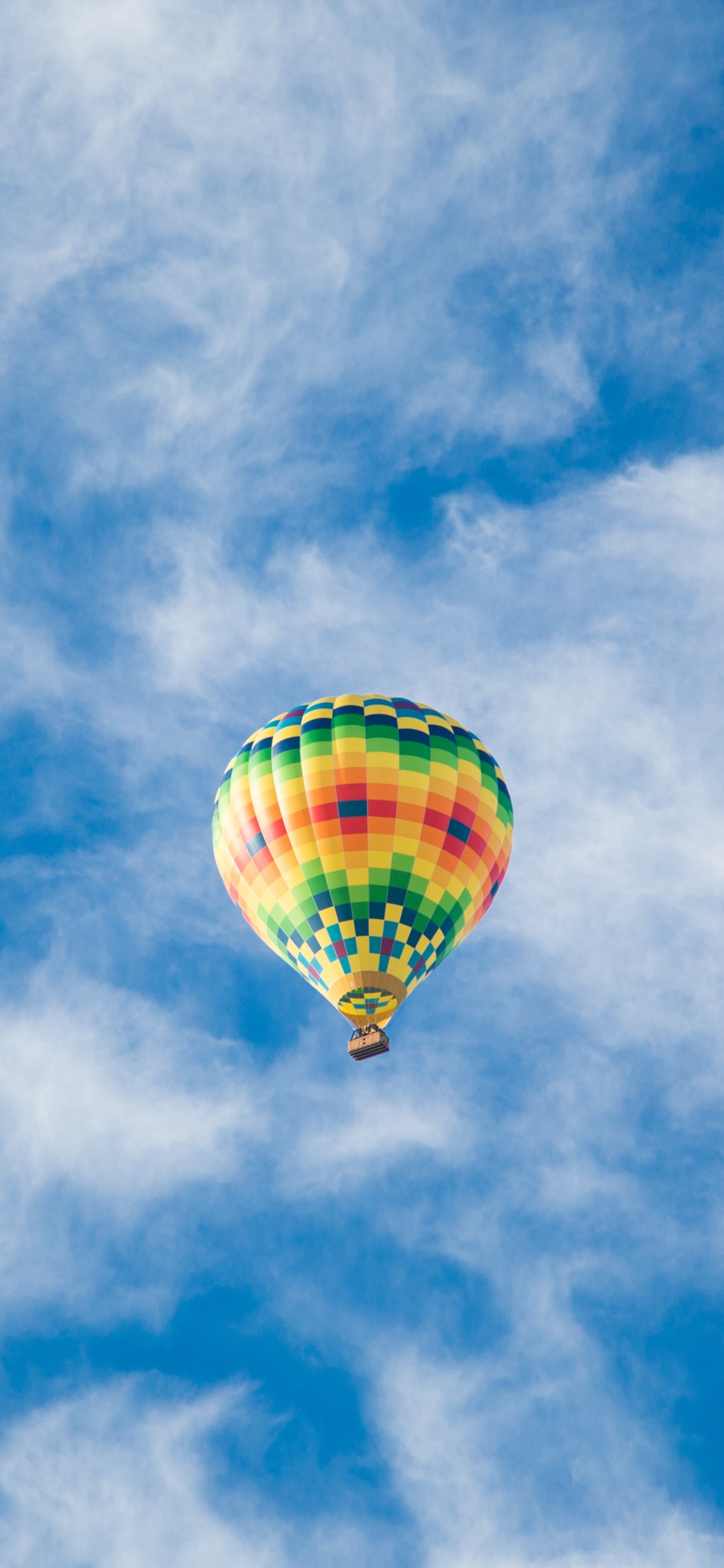 Yellow Hot Air Balloon in Mid Air Under Blue Sky During Daytime. Wallpaper in 1125x2436 Resolution