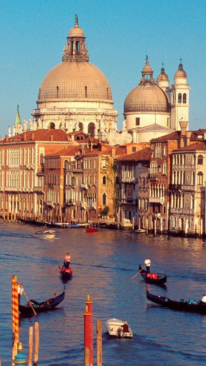 People Riding on Boat on River Between Concrete Buildings During Daytime. Wallpaper in 720x1280 Resolution