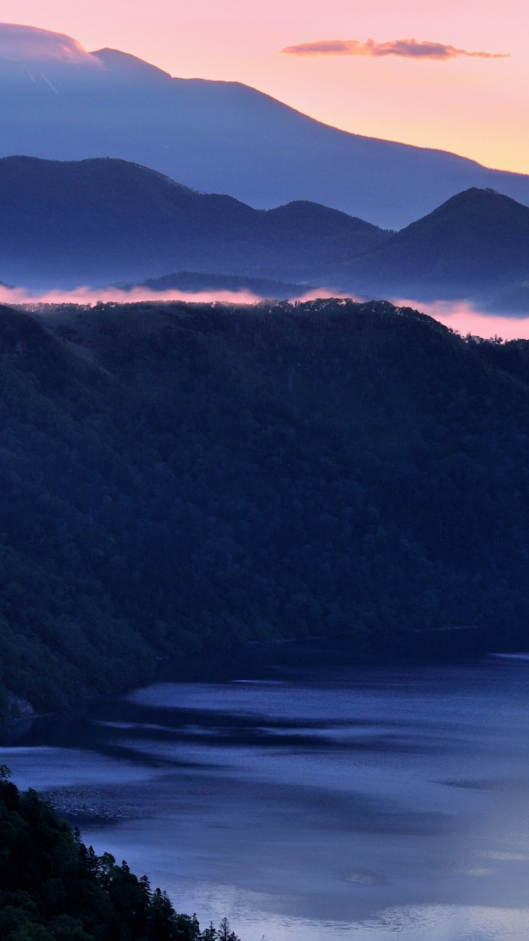 Green Mountains Near Body of Water During Daytime. Wallpaper in 750x1334 Resolution
