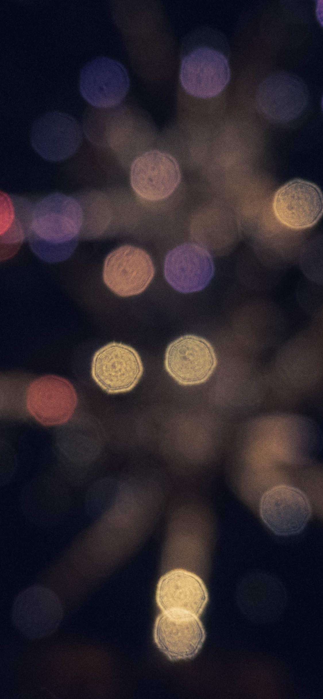 Woman With Red Hair in Front of White Lights. Wallpaper in 1125x2436 Resolution