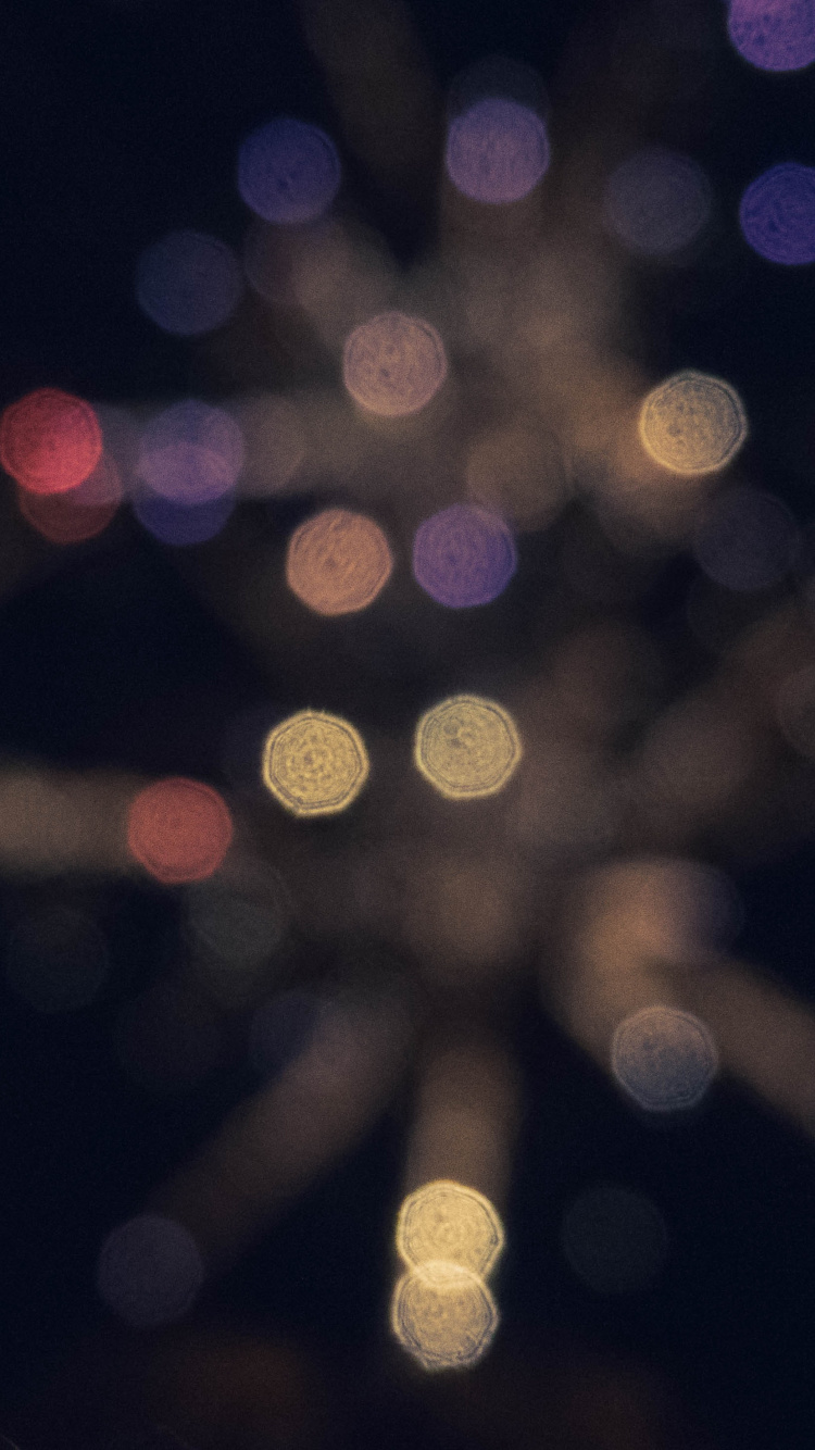 Woman With Red Hair in Front of White Lights. Wallpaper in 750x1334 Resolution