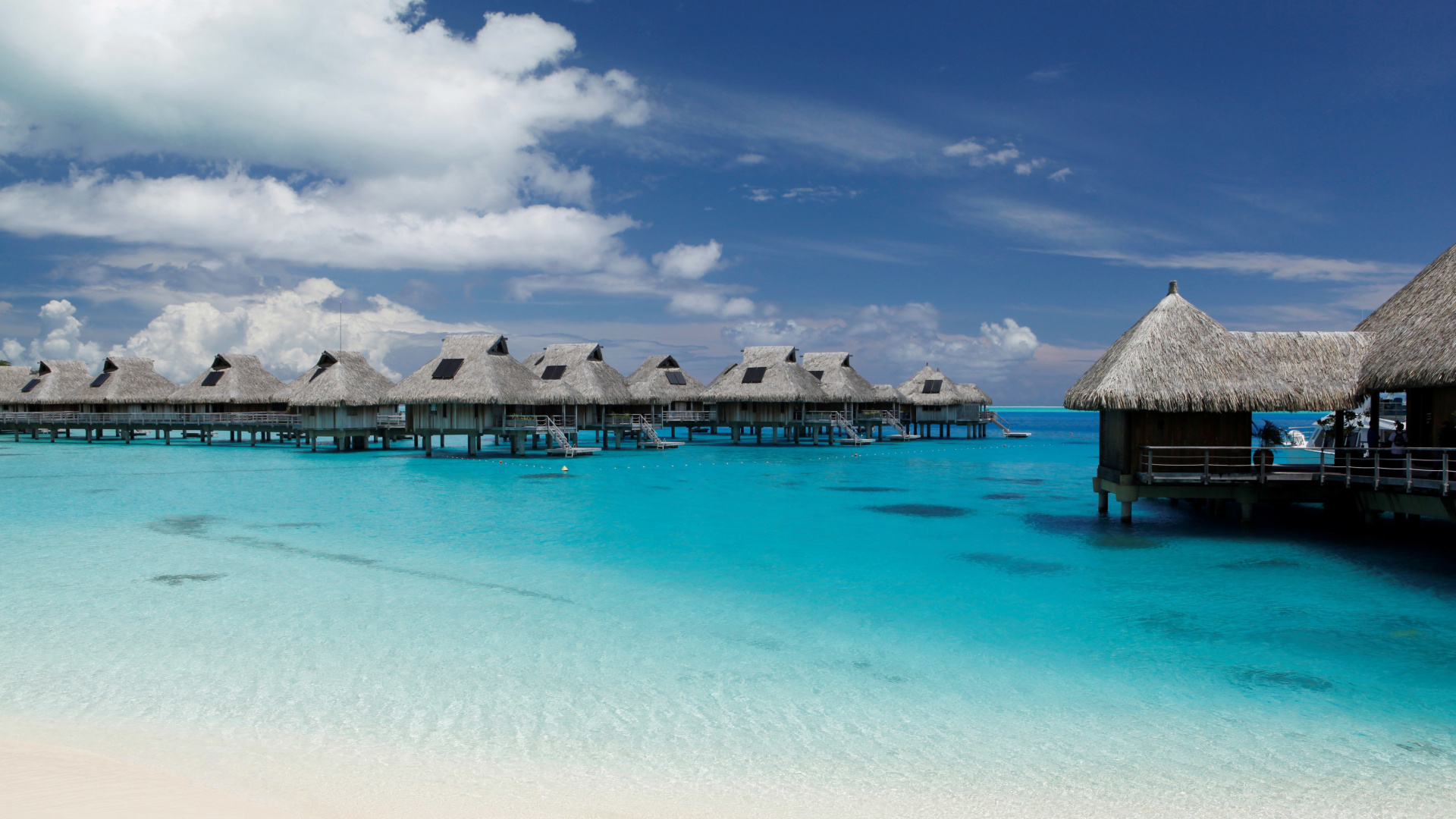 Brown Wooden Beach House on Beach During Daytime. Wallpaper in 1920x1080 Resolution