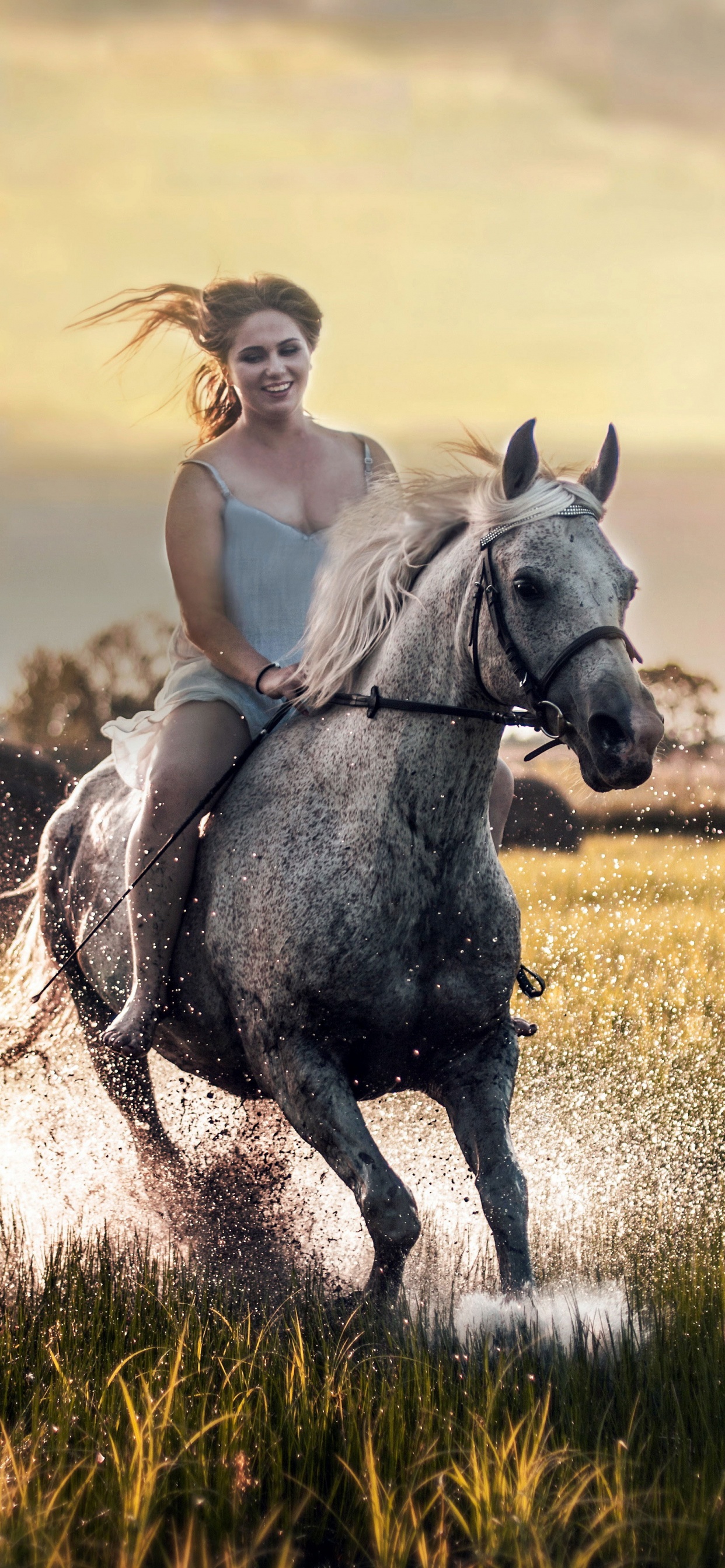 Mujer en Camiseta Blanca Cabalgando Sobre un Caballo Blanco en el Campo de Hierba Verde Durante el Día. Wallpaper in 1242x2688 Resolution