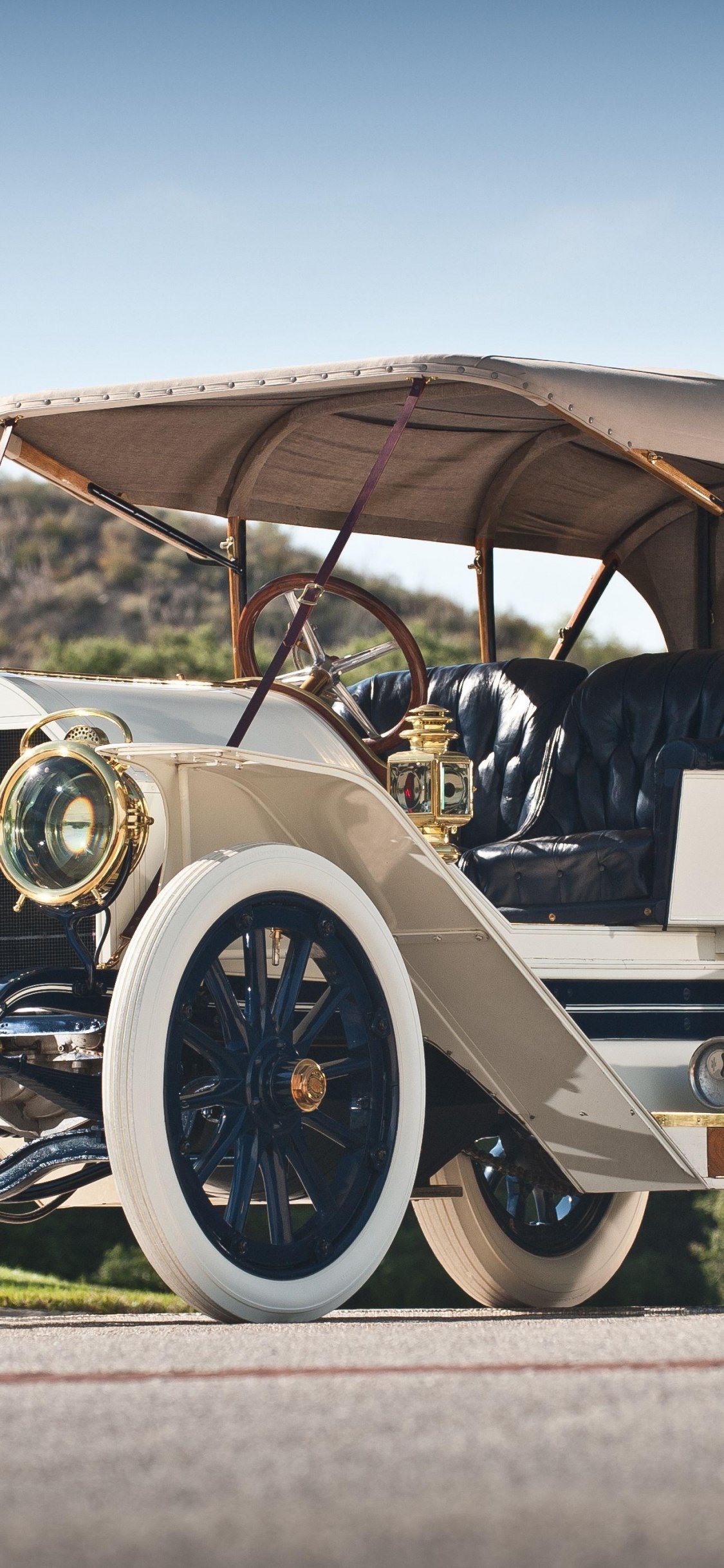Man and Woman Riding on Vintage Car During Daytime. Wallpaper in 1125x2436 Resolution