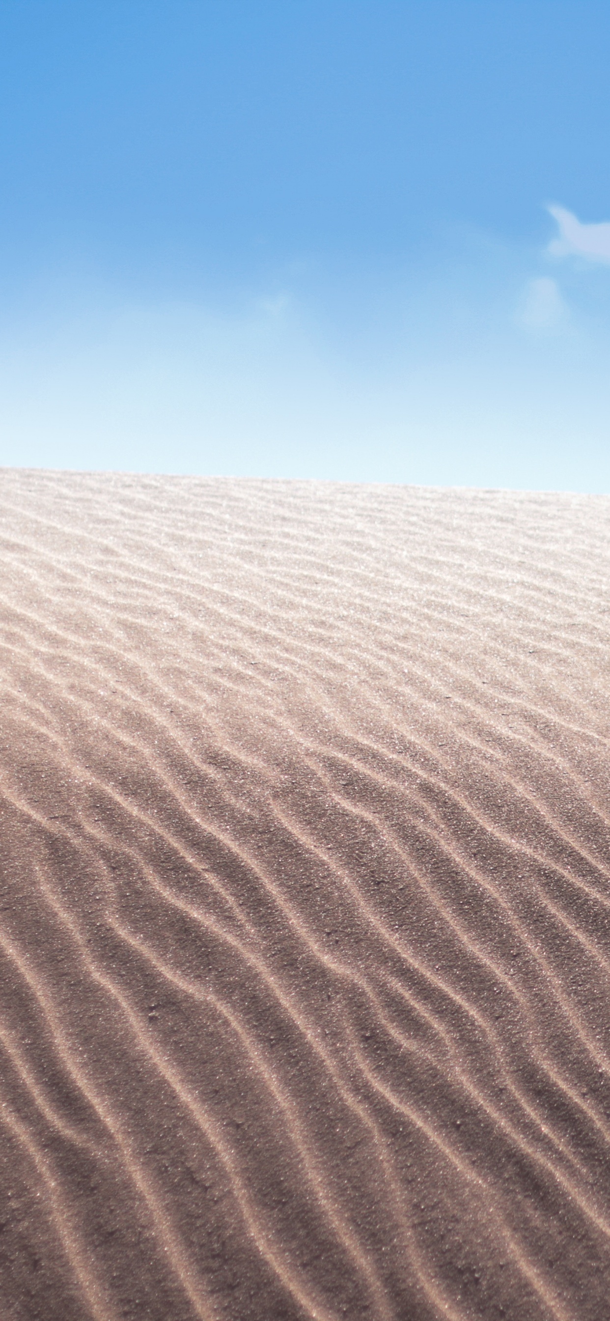 Brown Sand Under Blue Sky During Daytime. Wallpaper in 1242x2688 Resolution