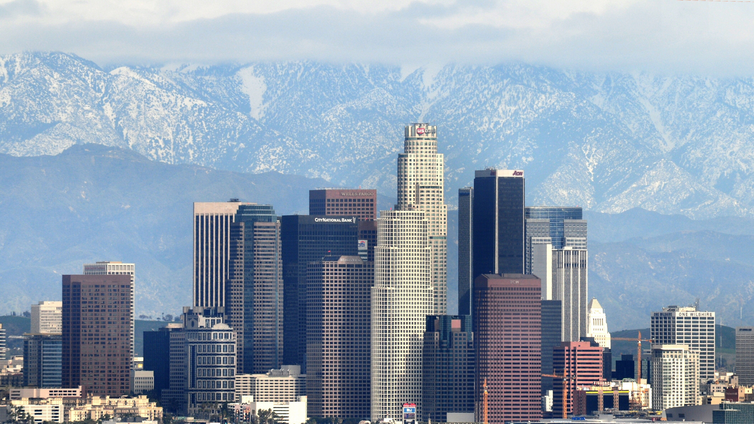 High Rise Buildings Near Mountain During Daytime. Wallpaper in 2560x1440 Resolution