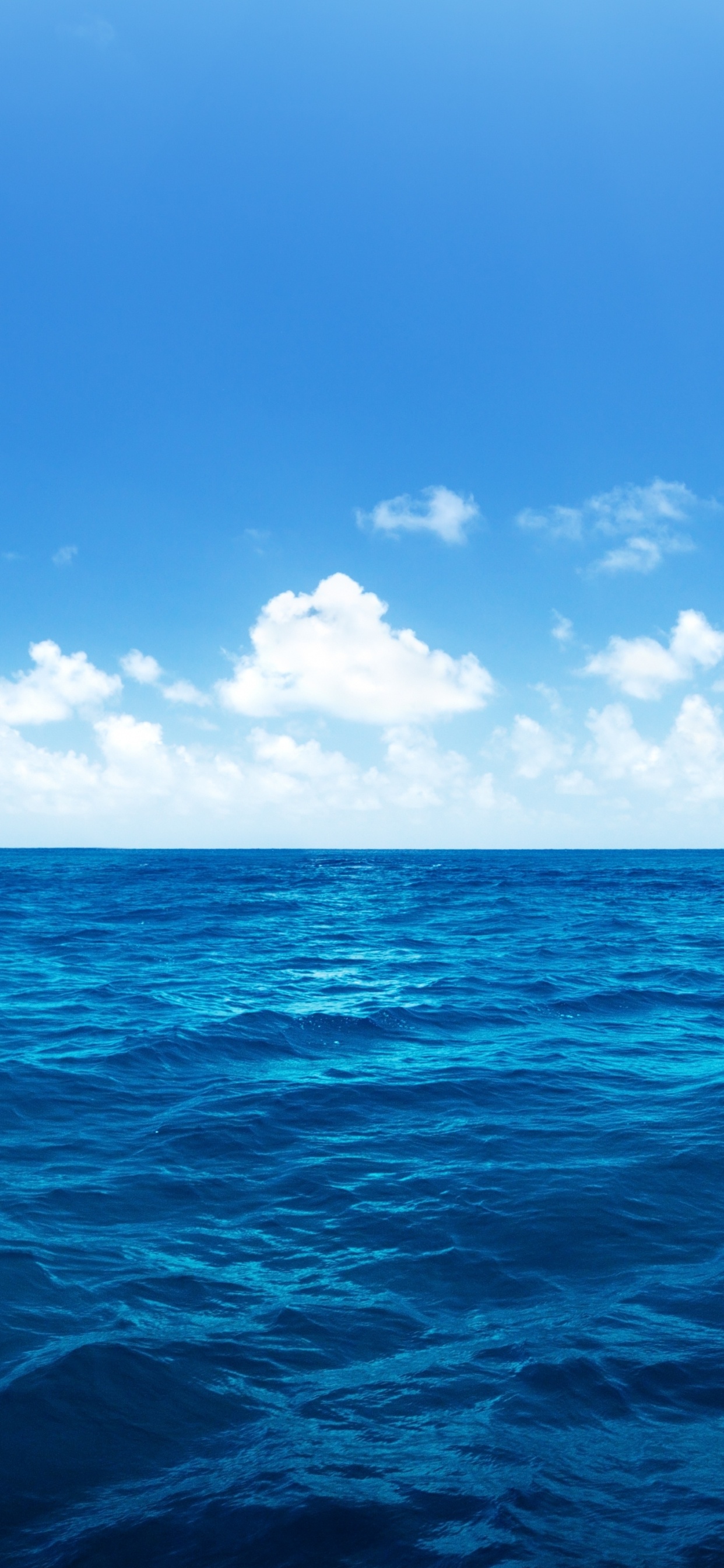 Blue Ocean Under Blue Sky and White Clouds During Daytime. Wallpaper in 1242x2688 Resolution
