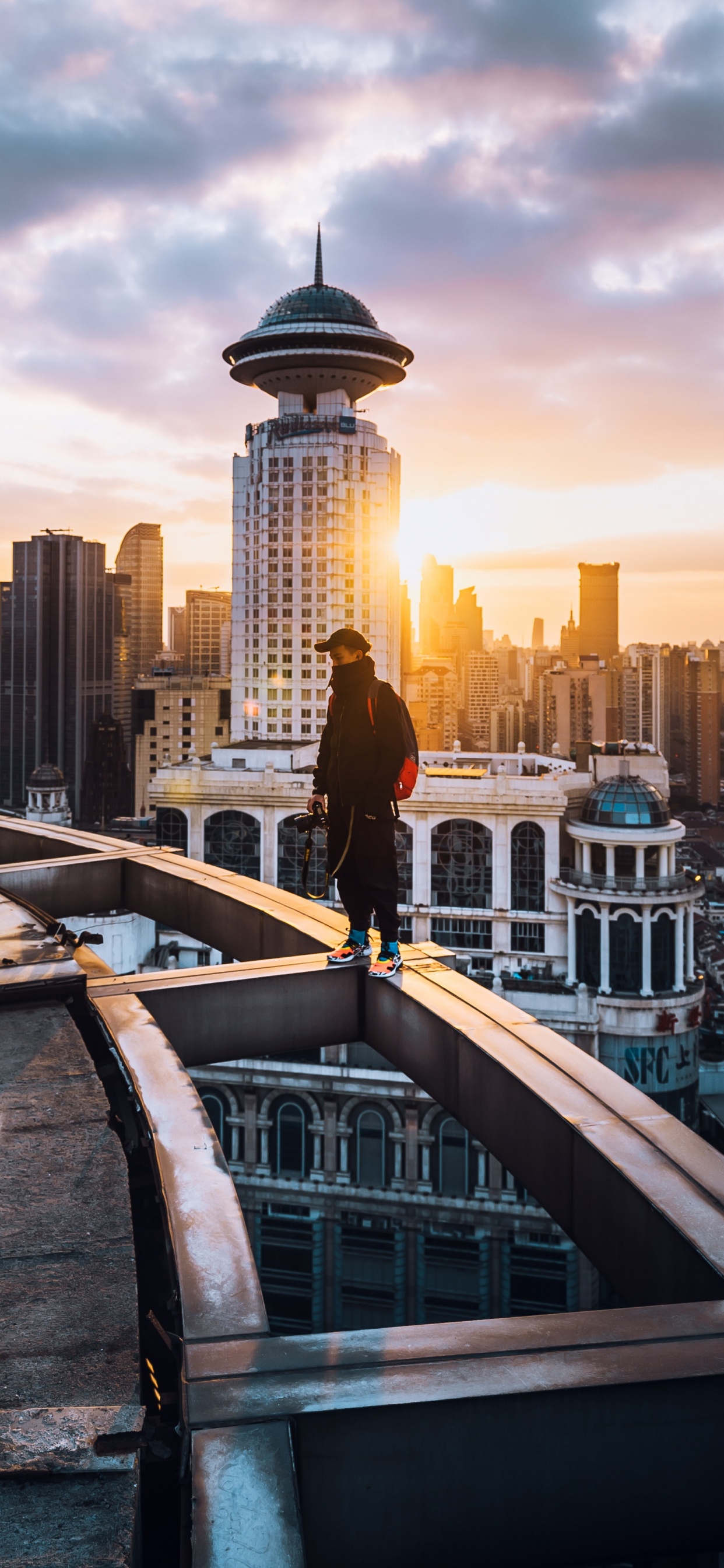 People Walking on Bridge Near City Buildings During Daytime. Wallpaper in 1242x2688 Resolution