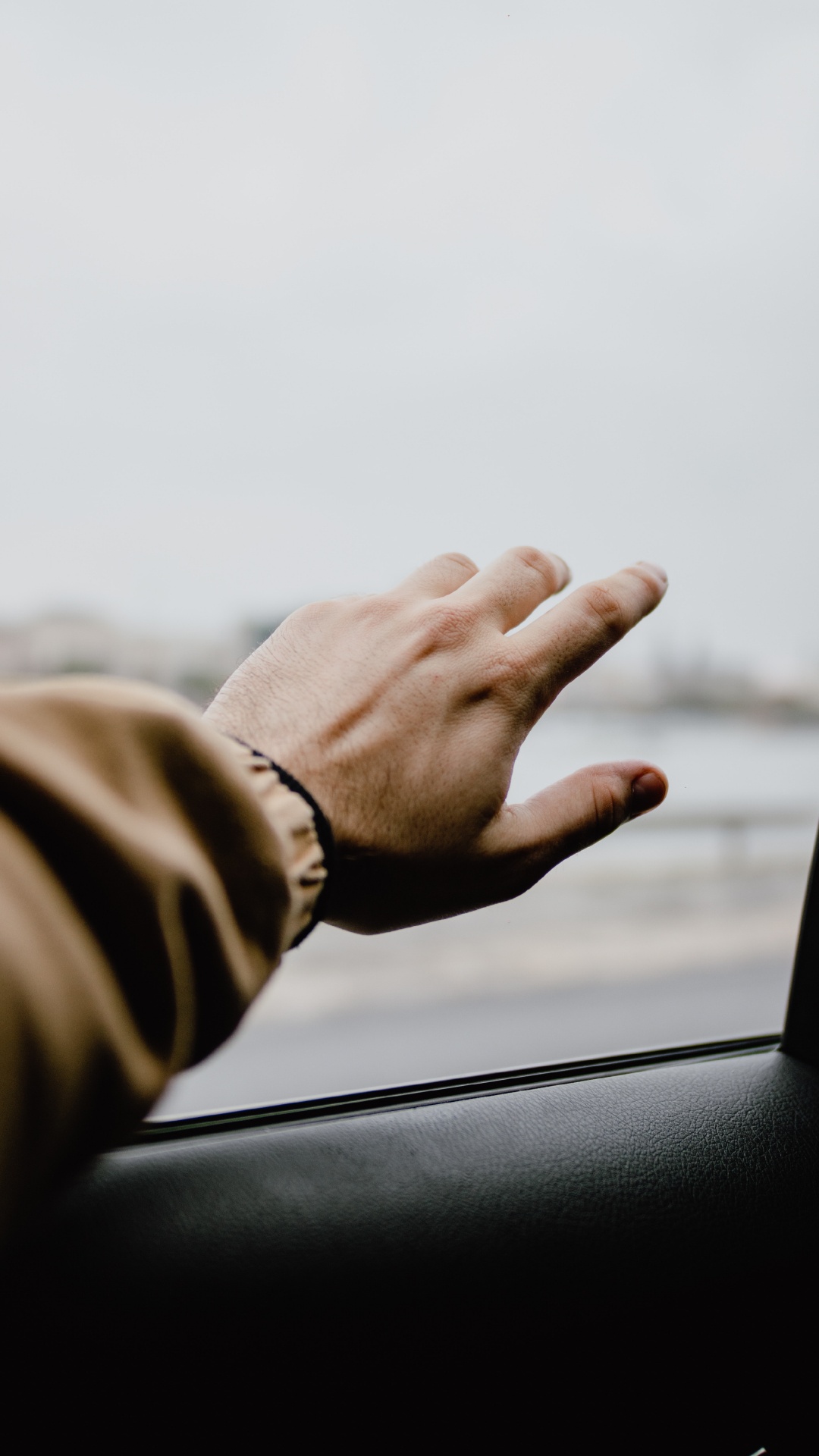 Person in Brown Jacket Holding Car Window. Wallpaper in 1080x1920 Resolution