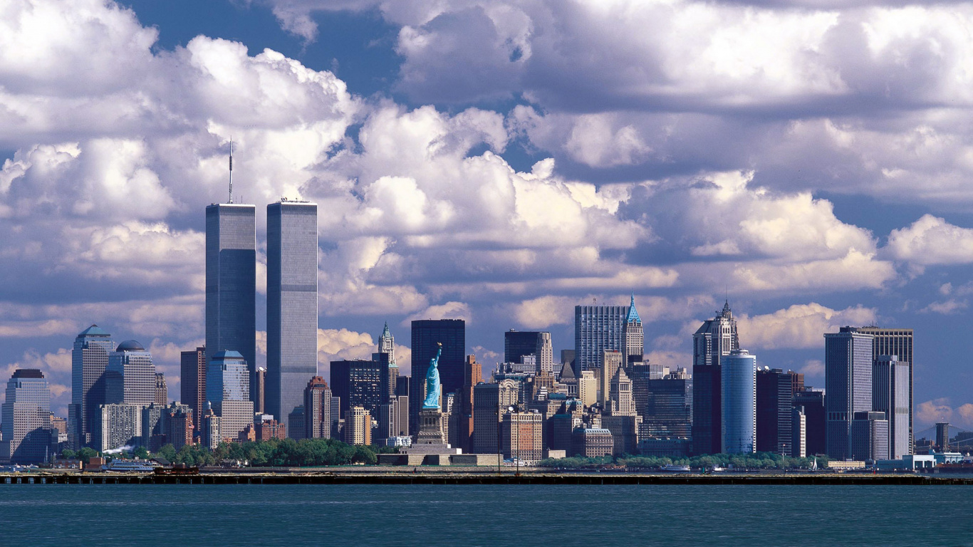 City Skyline Under White Clouds and Blue Sky During Daytime. Wallpaper in 1366x768 Resolution