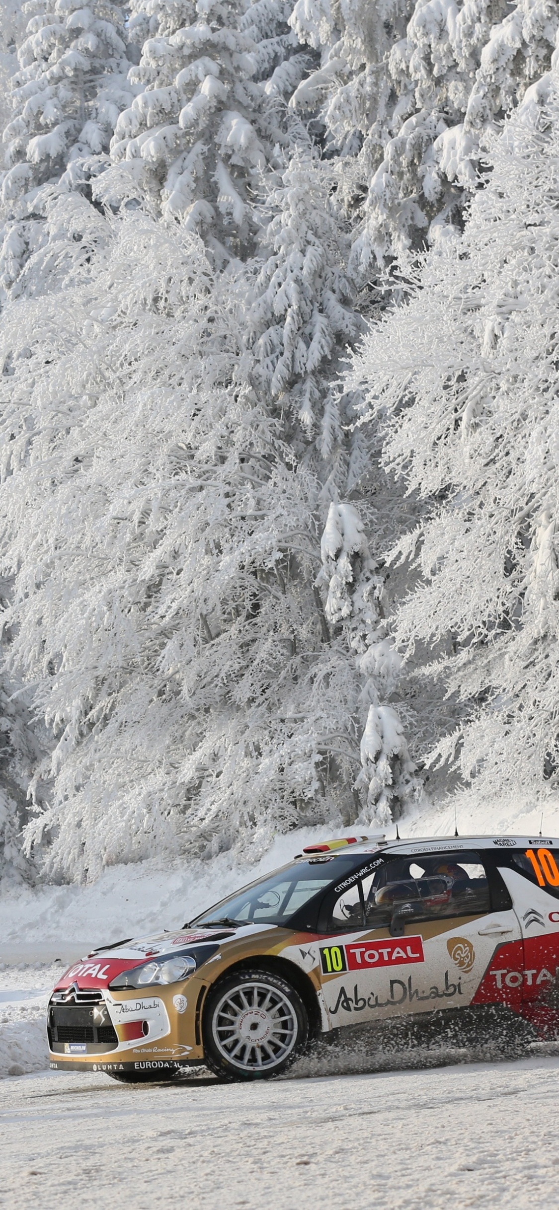 Black and Orange Chevrolet Camaro on Snow Covered Road. Wallpaper in 1125x2436 Resolution