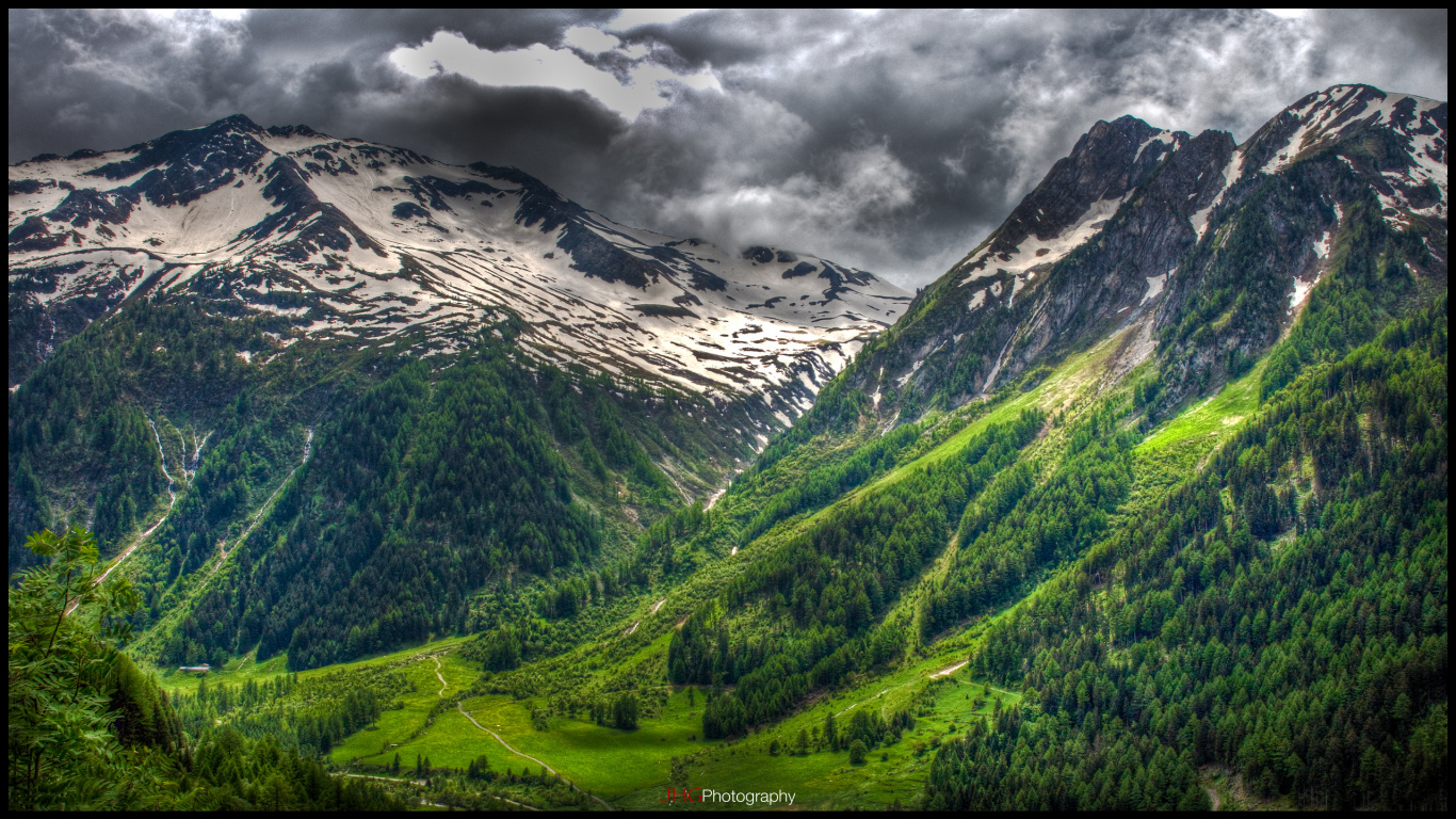 Green and White Mountains Under Gray Clouds. Wallpaper in 1366x768 Resolution