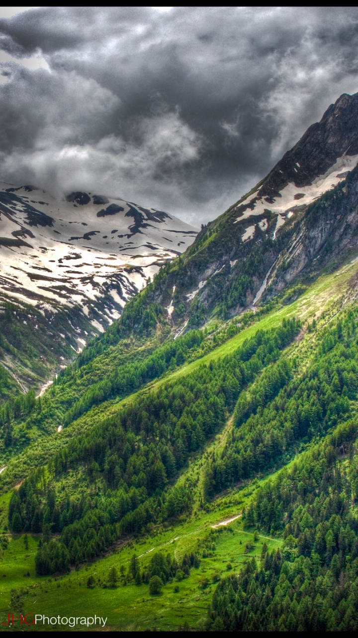 Green and White Mountains Under Gray Clouds. Wallpaper in 720x1280 Resolution