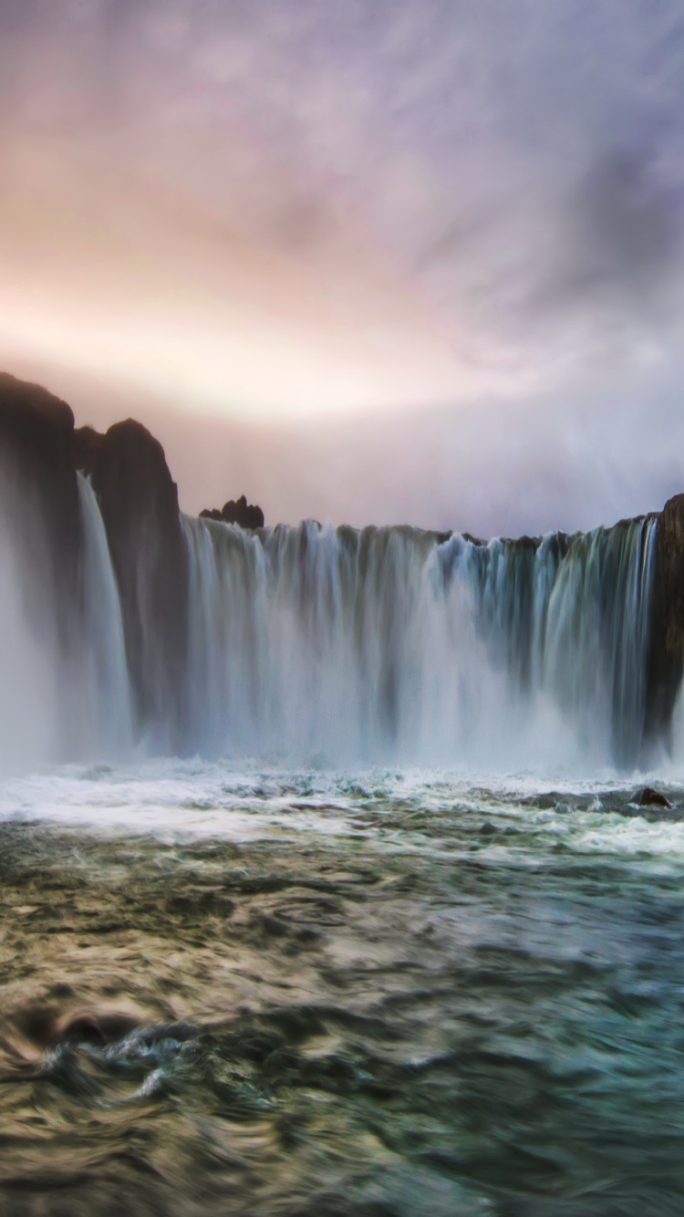 Water Falls Under Cloudy Sky. Wallpaper in 750x1334 Resolution