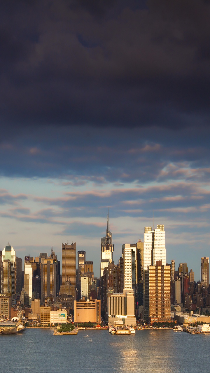 City Skyline Across Body of Water During Daytime. Wallpaper in 720x1280 Resolution