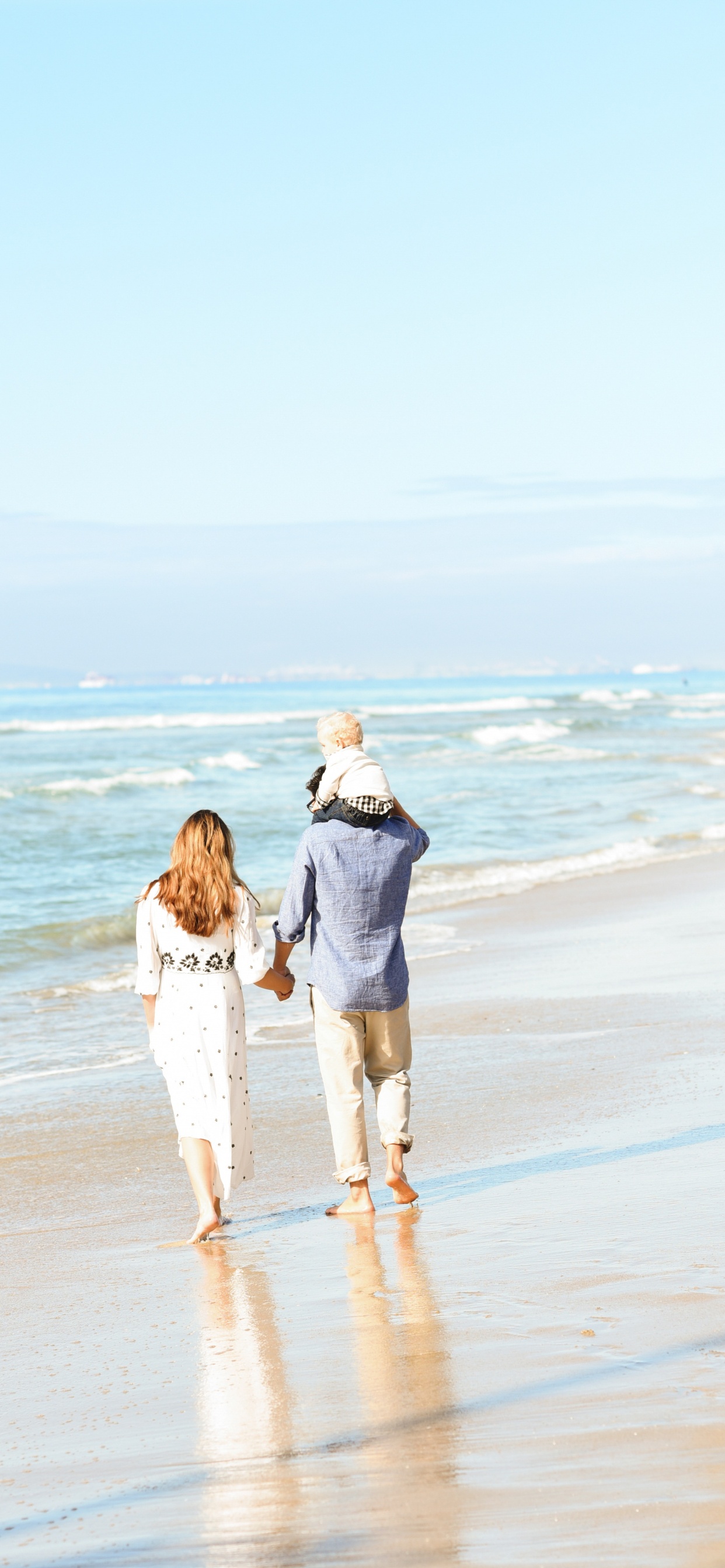 Couple Walking on Beach During Daytime. Wallpaper in 1242x2688 Resolution
