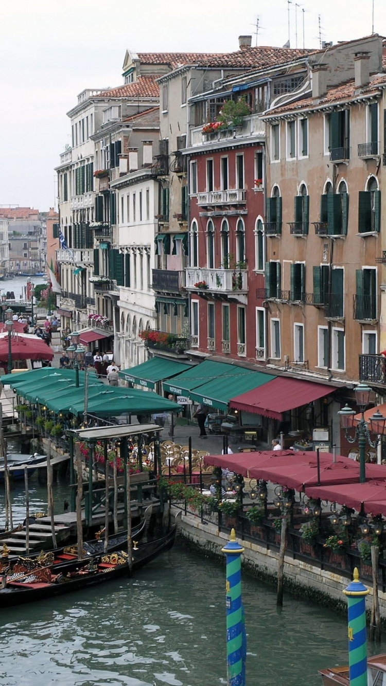 People Walking on Wooden Dock Near Buildings During Daytime. Wallpaper in 750x1334 Resolution