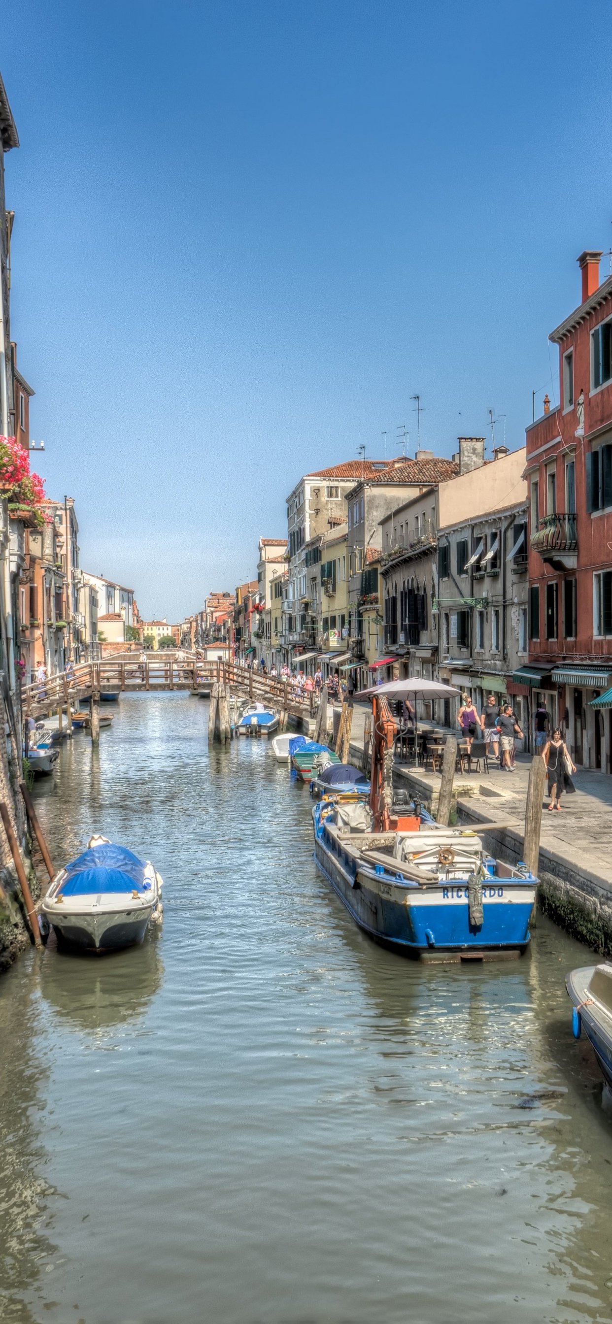 Blue and White Boat on River Between Buildings During Daytime. Wallpaper in 1242x2688 Resolution