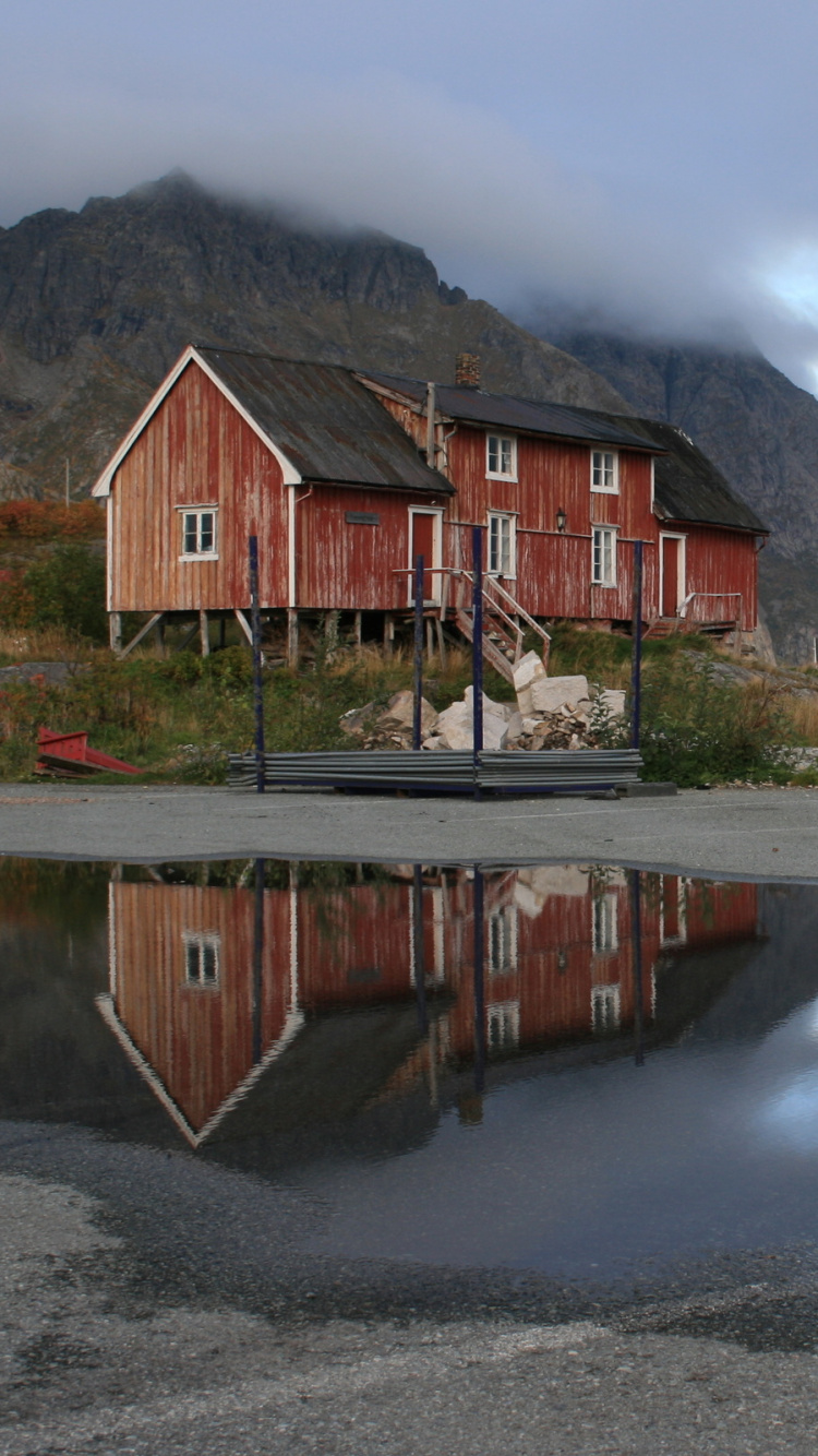 Brown Wooden House Near Body of Water During Daytime. Wallpaper in 750x1334 Resolution