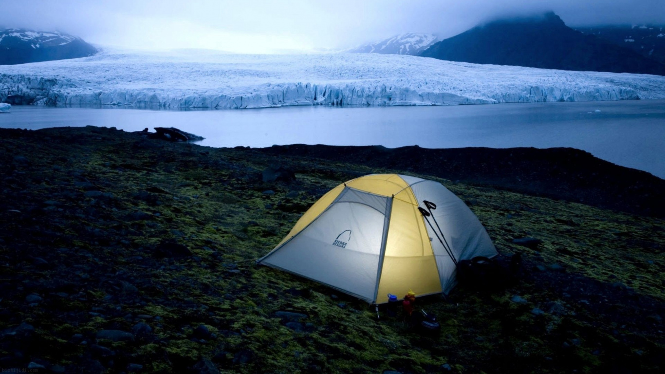 Yellow Tent on Green Grass Field Near Snow Covered Mountain During Daytime. Wallpaper in 1366x768 Resolution