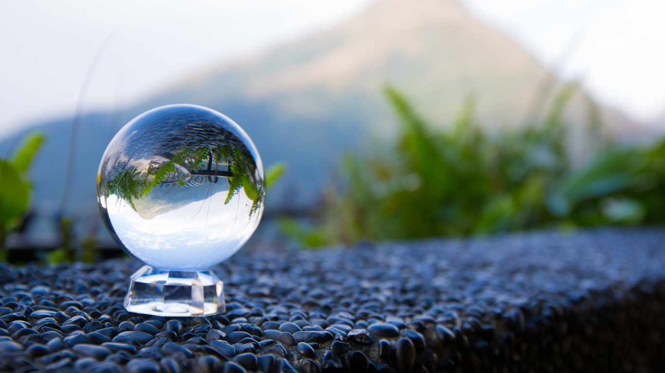 Clear Glass Ball on Black and White Stone. Wallpaper in 1366x768 Resolution