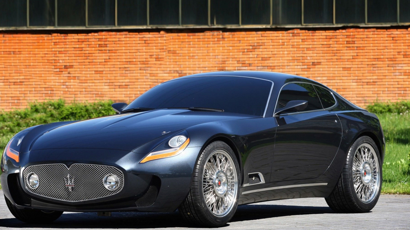 Black Porsche 911 Parked Near Brown Brick Wall. Wallpaper in 1366x768 Resolution
