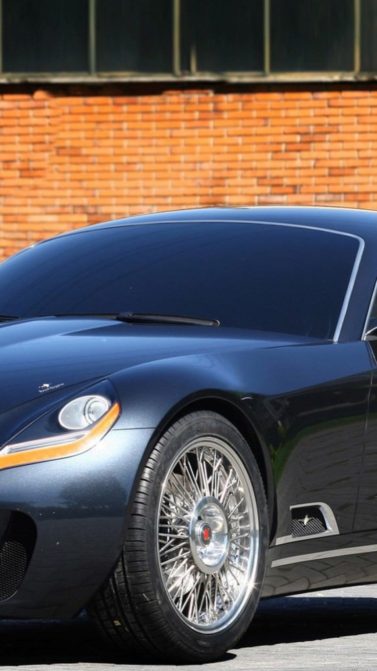 Black Porsche 911 Parked Near Brown Brick Wall. Wallpaper in 750x1334 Resolution