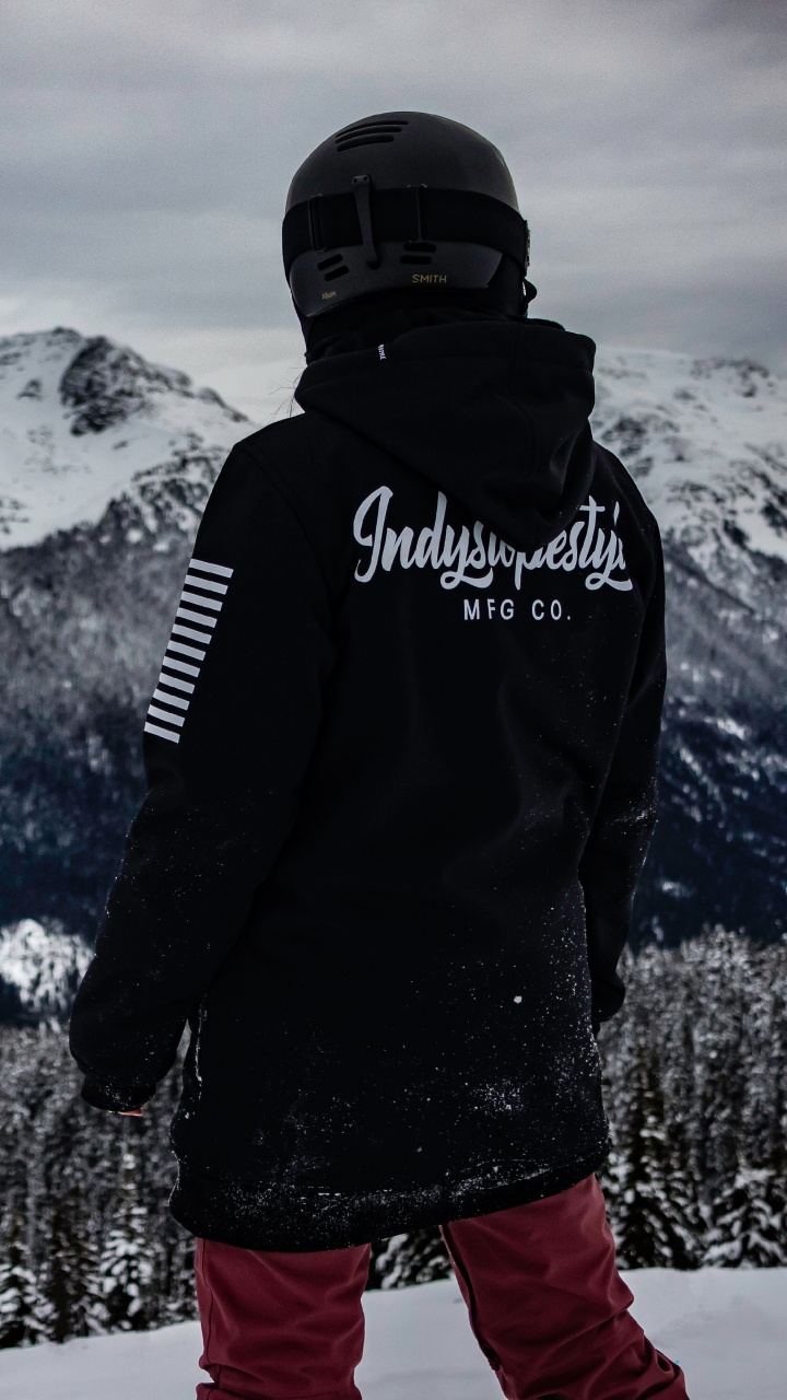 Man in Black Jacket and Red Pants Standing on Snow Covered Ground. Wallpaper in 720x1280 Resolution