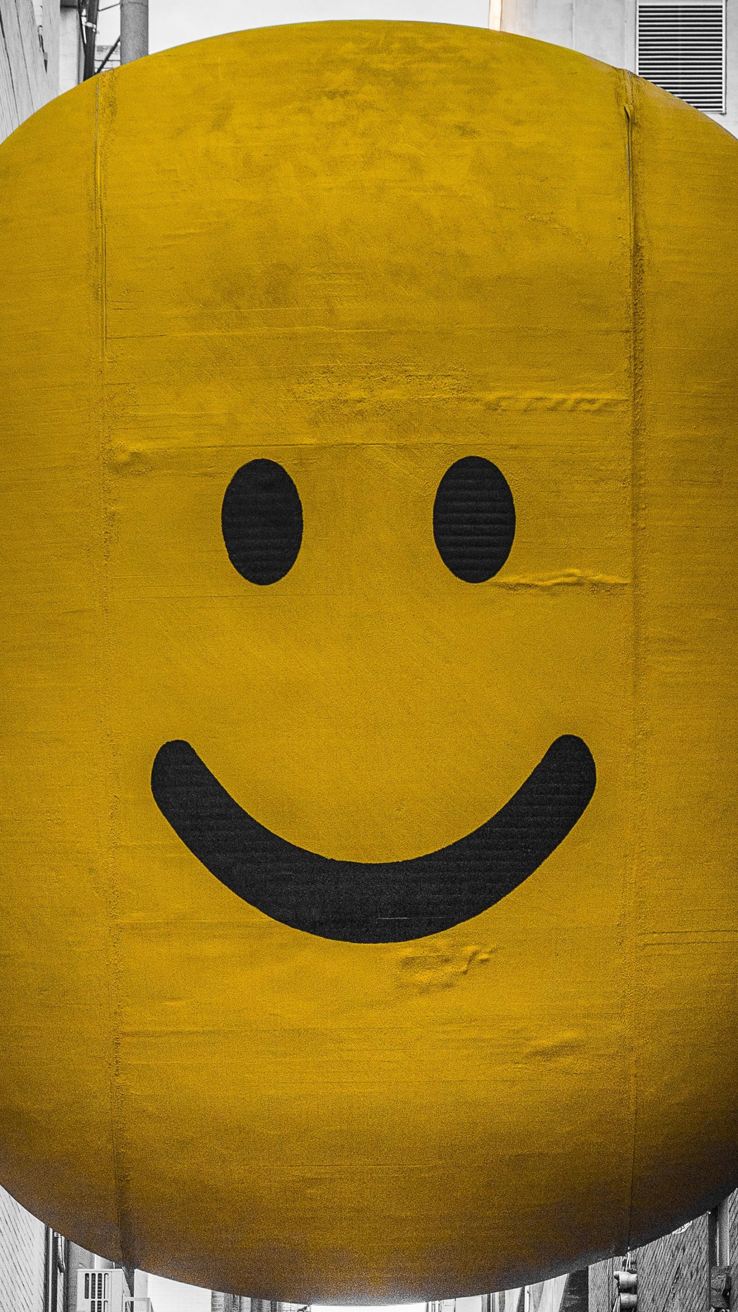 Yellow Smiley Balloon on Gray Wooden Plank. Wallpaper in 1440x2560 Resolution