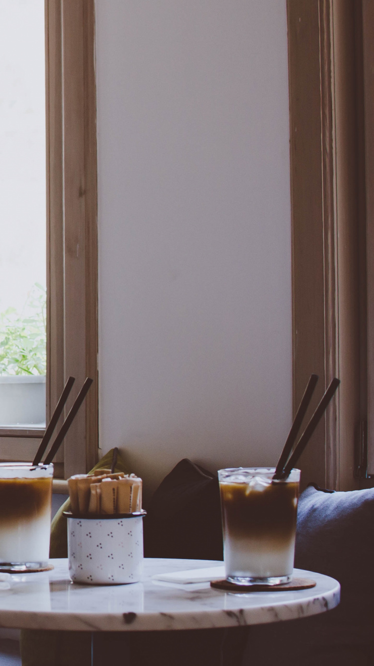 Taza de Vidrio Transparente Sobre Platillo de Cerámica Blanca Sobre Mesa Azul. Wallpaper in 750x1334 Resolution