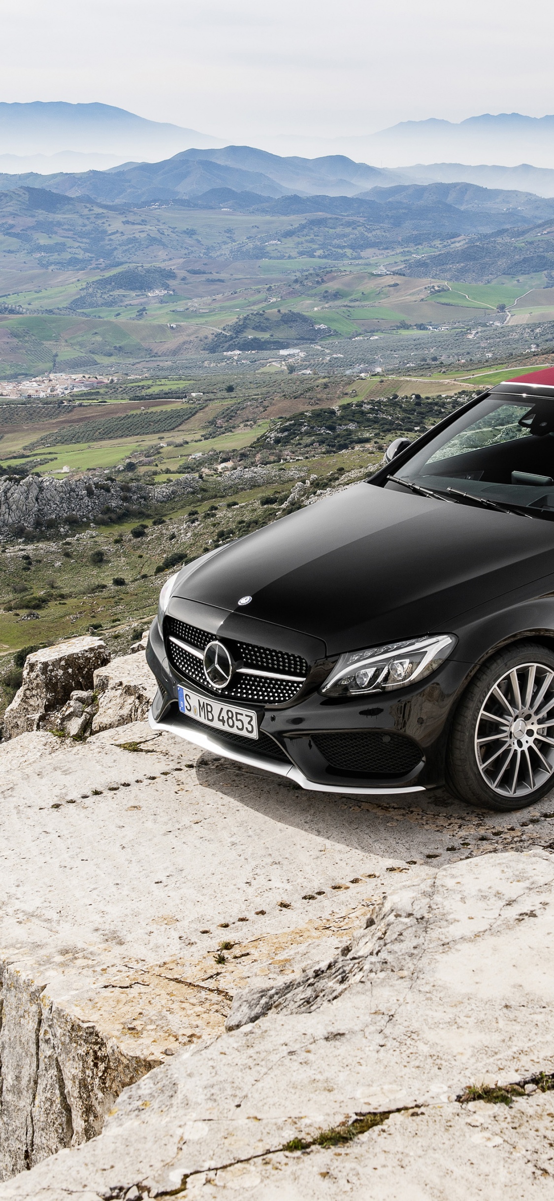 Black Mercedes Benz Coupe on Gray Rock. Wallpaper in 1125x2436 Resolution