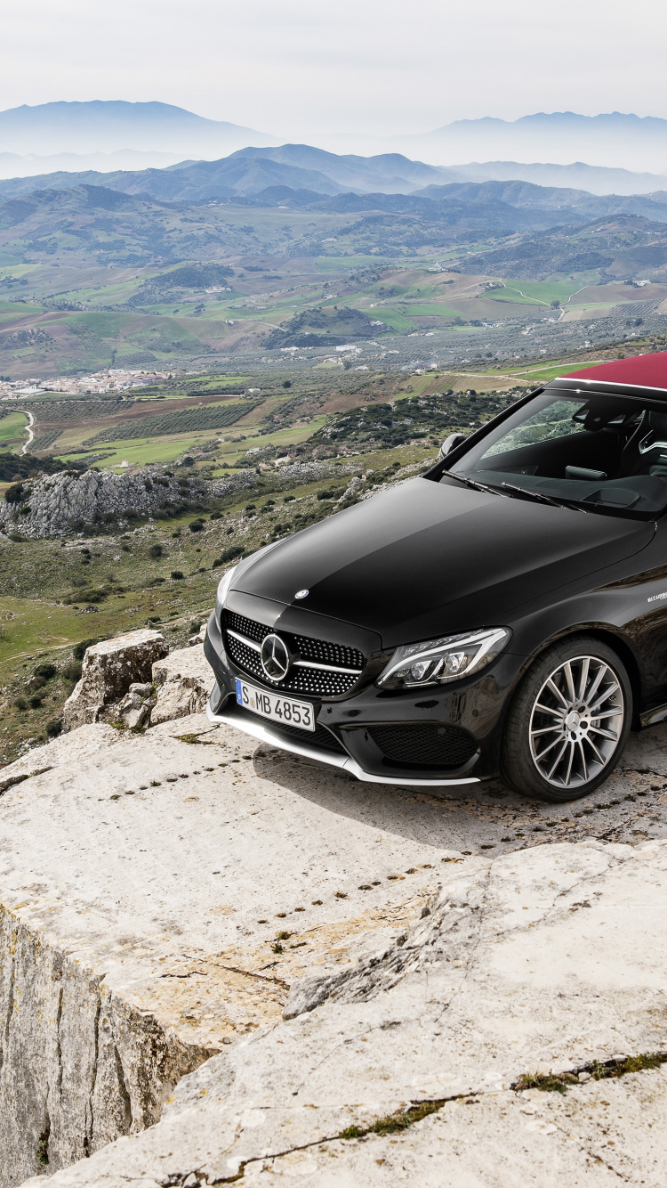 Black Mercedes Benz Coupe on Gray Rock. Wallpaper in 750x1334 Resolution