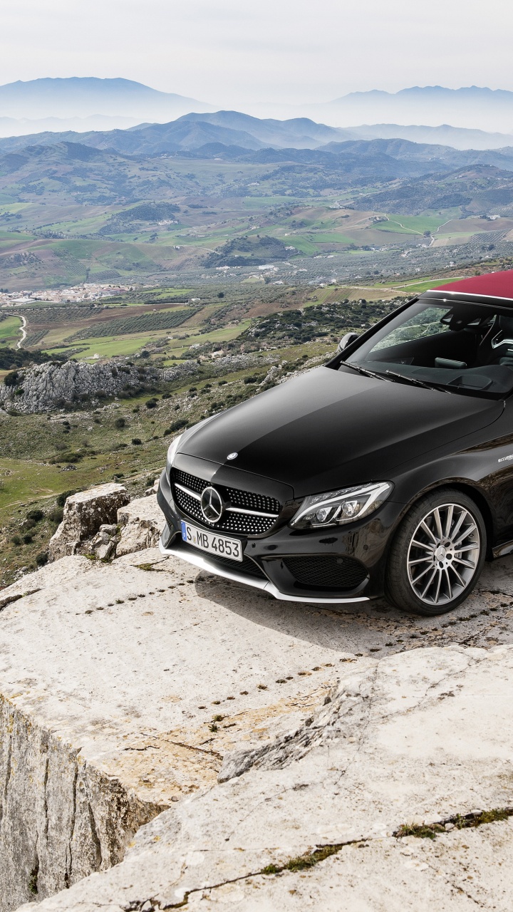 Schwarzes Mercedes Benz Coupe Auf Grauem Felsen. Wallpaper in 720x1280 Resolution