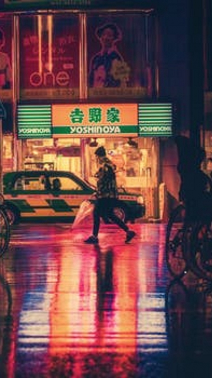 People Walking on Sidewalk During Night Time. Wallpaper in 720x1280 Resolution