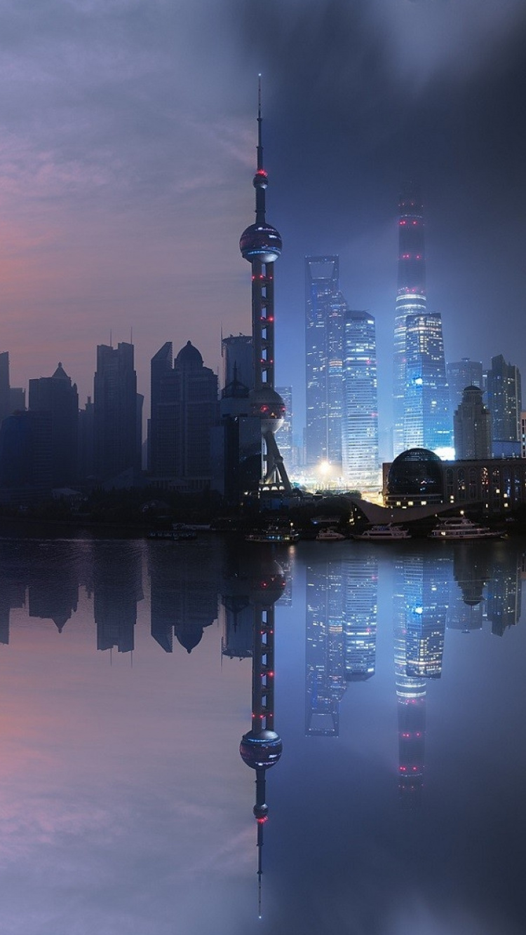 City Skyline Across Body of Water During Night Time. Wallpaper in 750x1334 Resolution