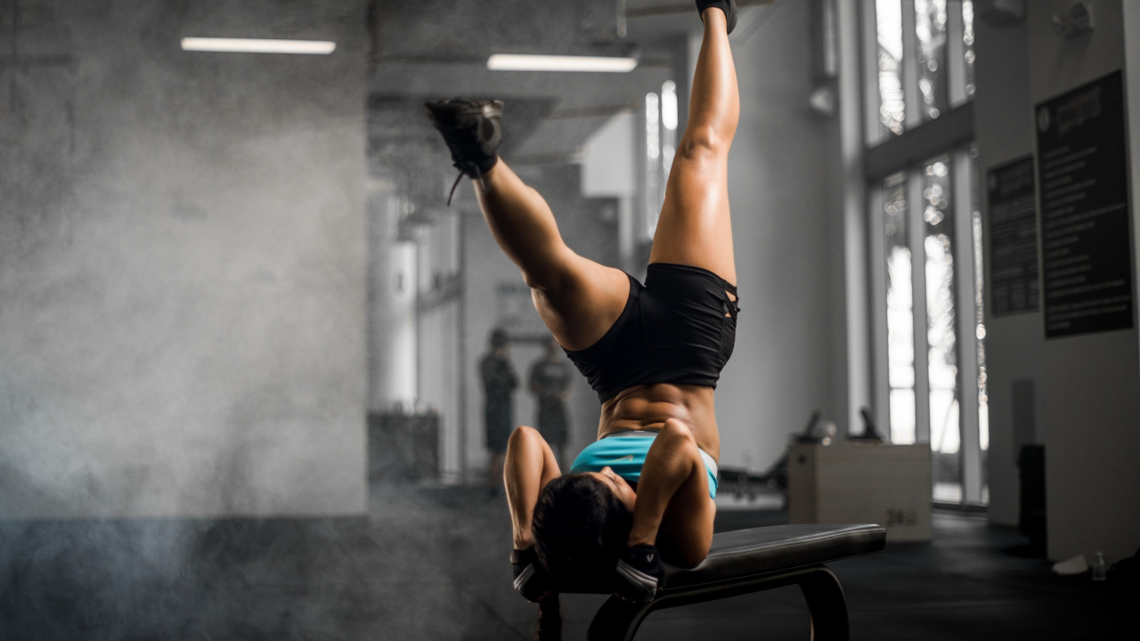 Woman in Red Sports Bra and Black Shorts Doing Exercise. Wallpaper in 1280x720 Resolution