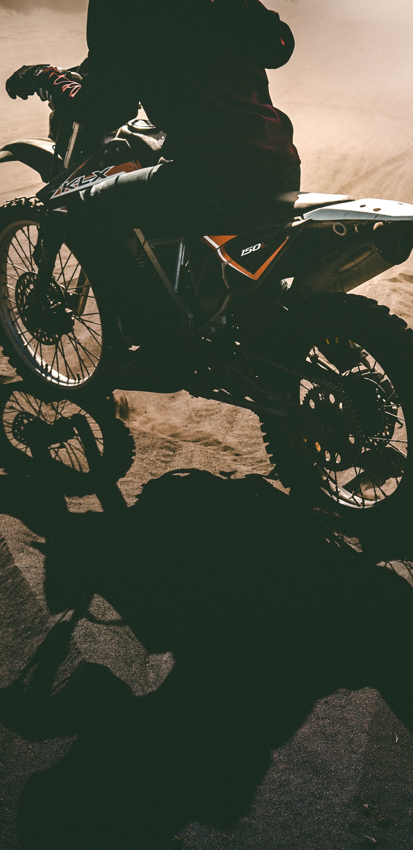 Grayscale Photo of Man Riding Motorcycle on Desert. Wallpaper in 1440x2960 Resolution