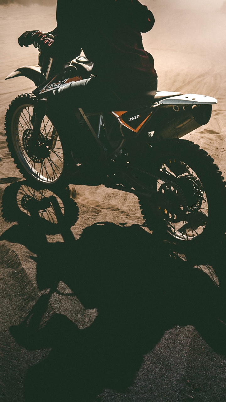 Grayscale Photo of Man Riding Motorcycle on Desert. Wallpaper in 720x1280 Resolution