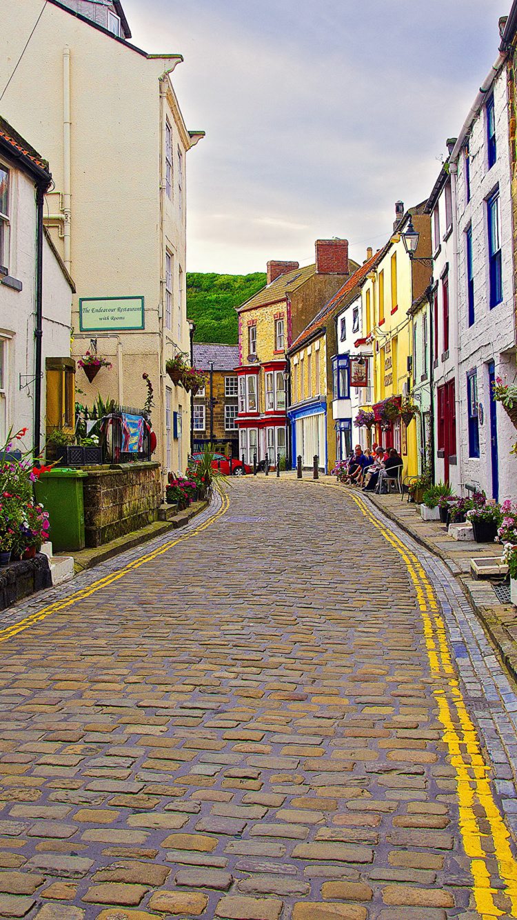 Gray Concrete Road Between Houses During Daytime. Wallpaper in 750x1334 Resolution