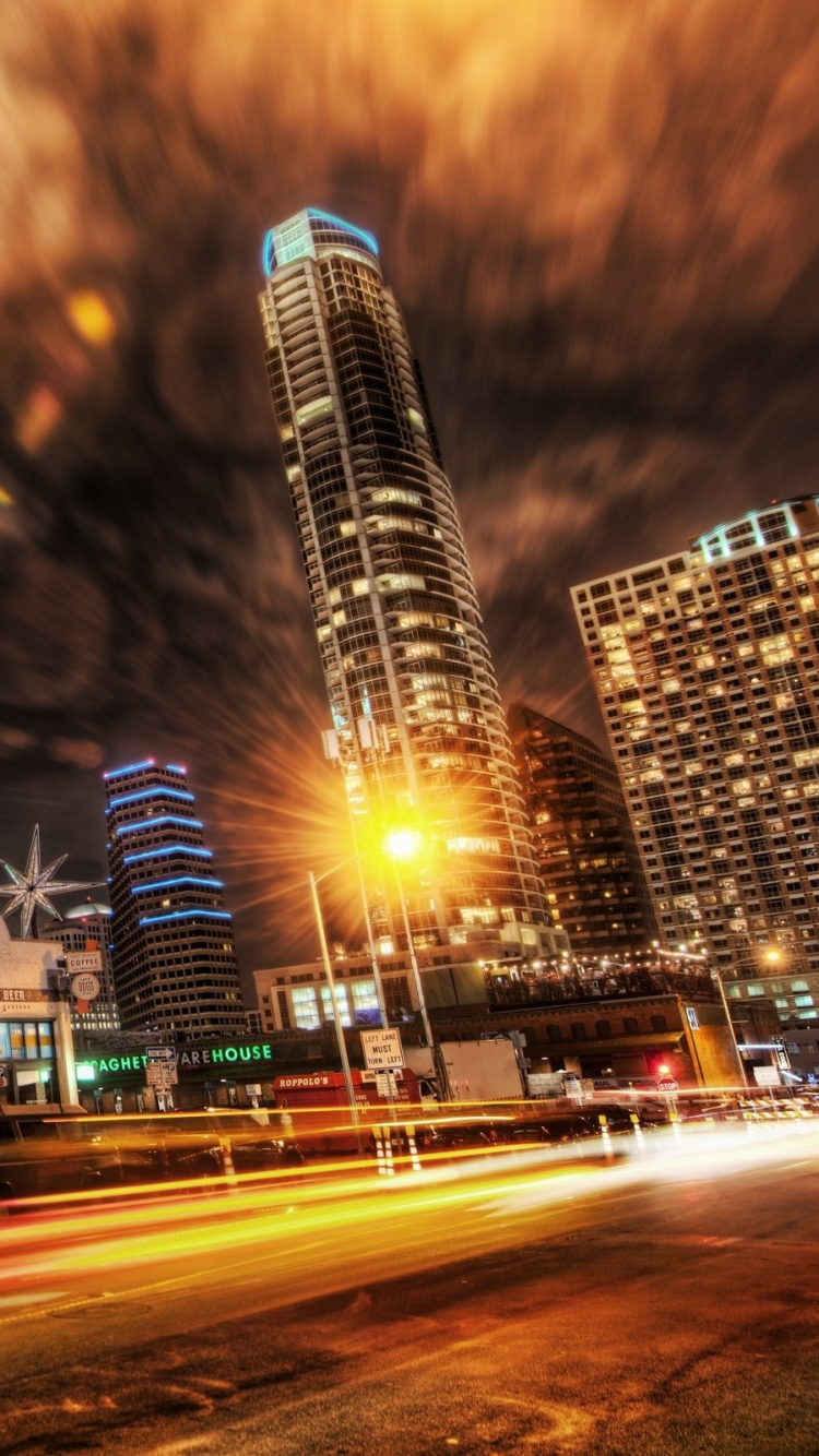 Cars on Road Near High Rise Buildings During Night Time. Wallpaper in 750x1334 Resolution