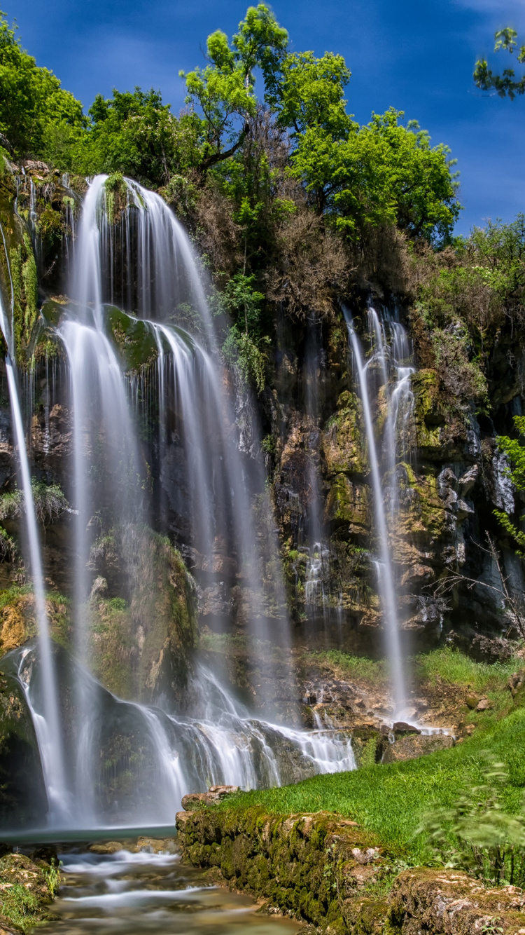Waterfalls on Green Grass Field Under Blue Sky During Daytime. Wallpaper in 750x1334 Resolution