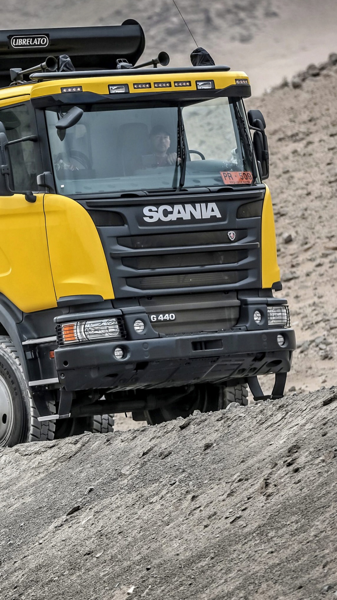 Black and Yellow Truck on Gray Sand During Daytime. Wallpaper in 1080x1920 Resolution