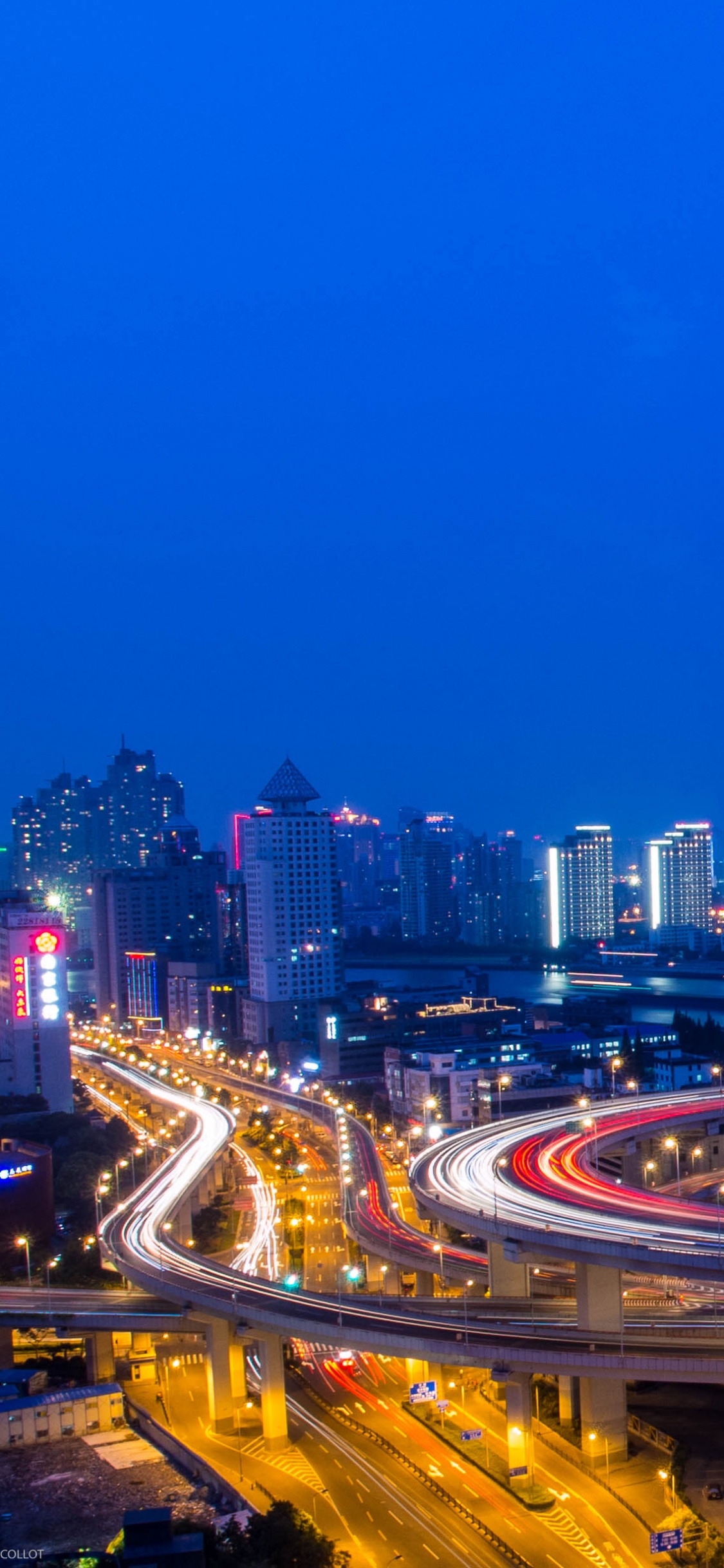City With High Rise Buildings During Night Time. Wallpaper in 1125x2436 Resolution
