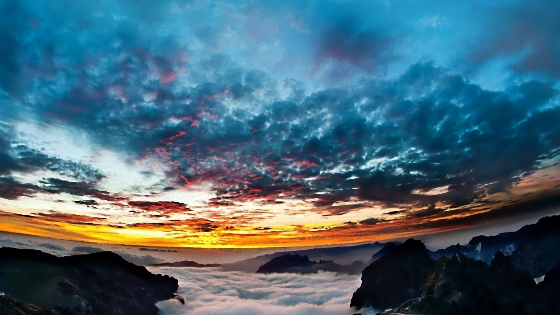 Silhouette of Person Standing on Rock Formation Under Blue and White Cloudy Sky During Daytime. Wallpaper in 1920x1080 Resolution