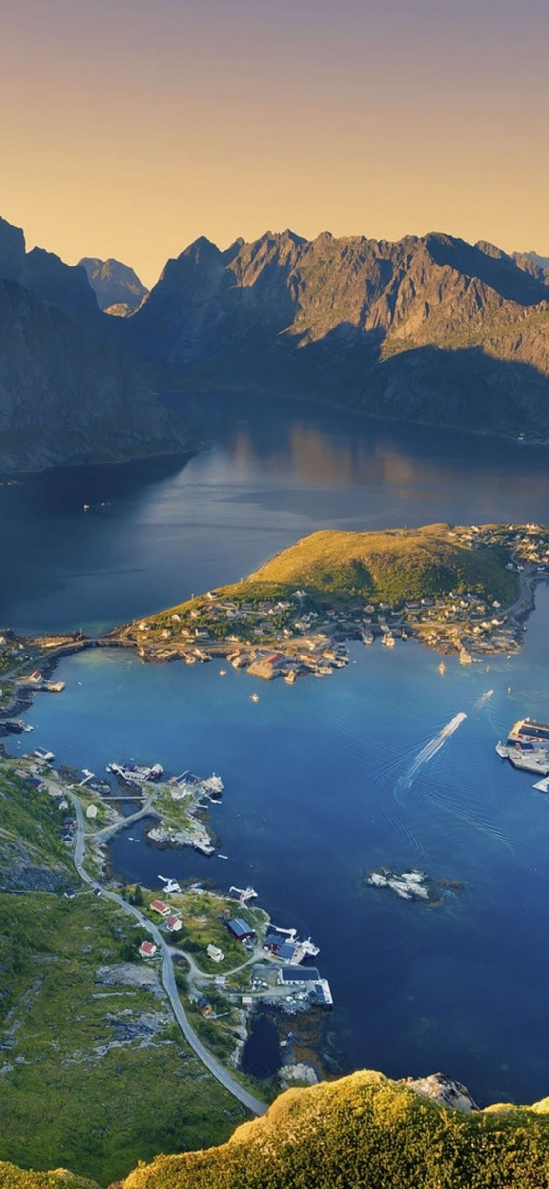 Aerial View of Green and Brown Mountains and Body of Water During Daytime. Wallpaper in 1125x2436 Resolution