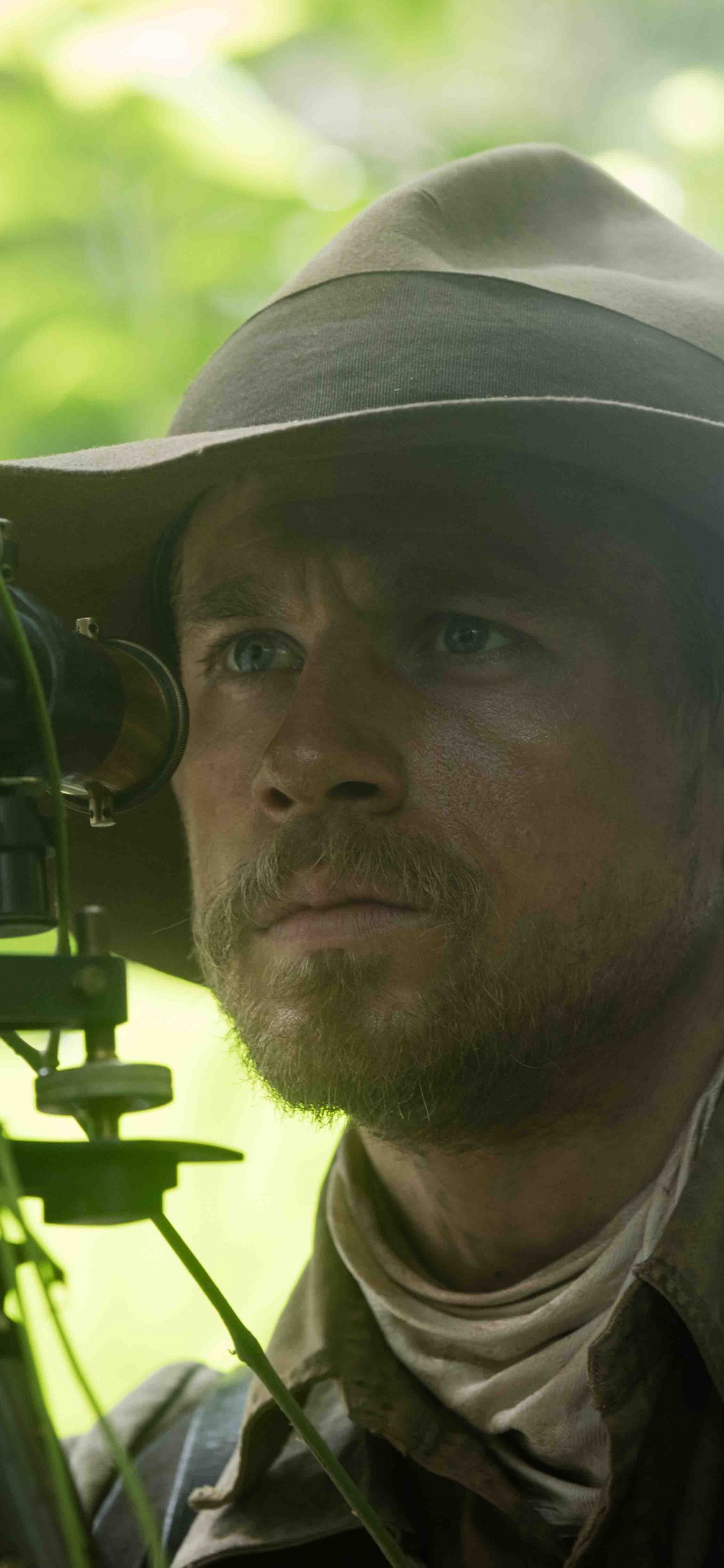 Man in Green and Brown Camouflage Uniform Holding Black Camera. Wallpaper in 1242x2688 Resolution