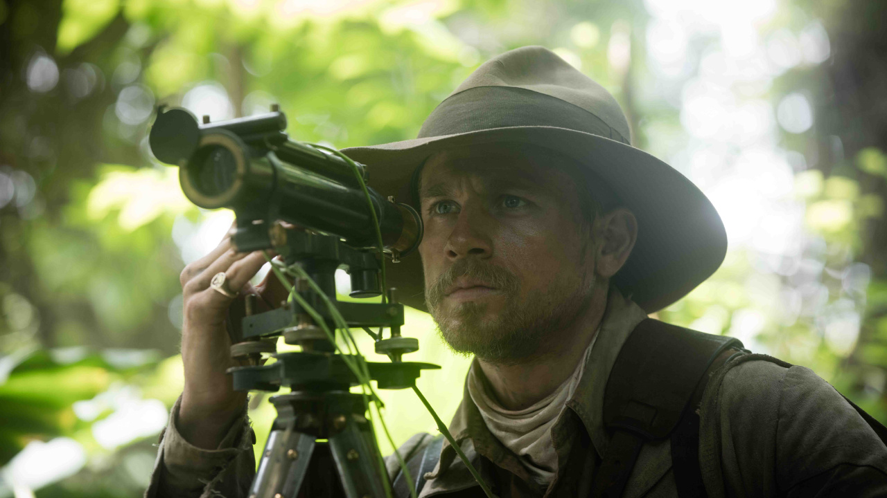 Man in Green and Brown Camouflage Uniform Holding Black Camera. Wallpaper in 1280x720 Resolution