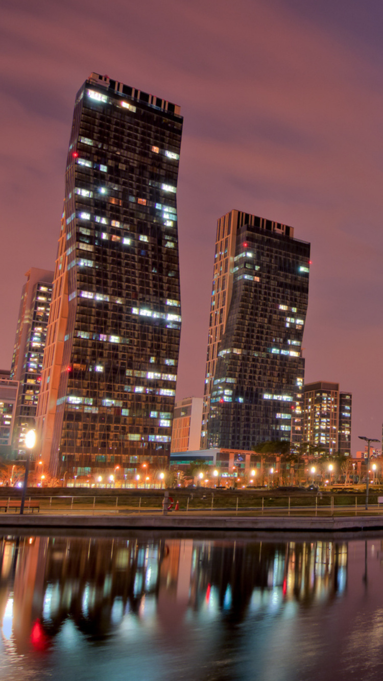 City Skyline Across Body of Water During Night Time. Wallpaper in 750x1334 Resolution